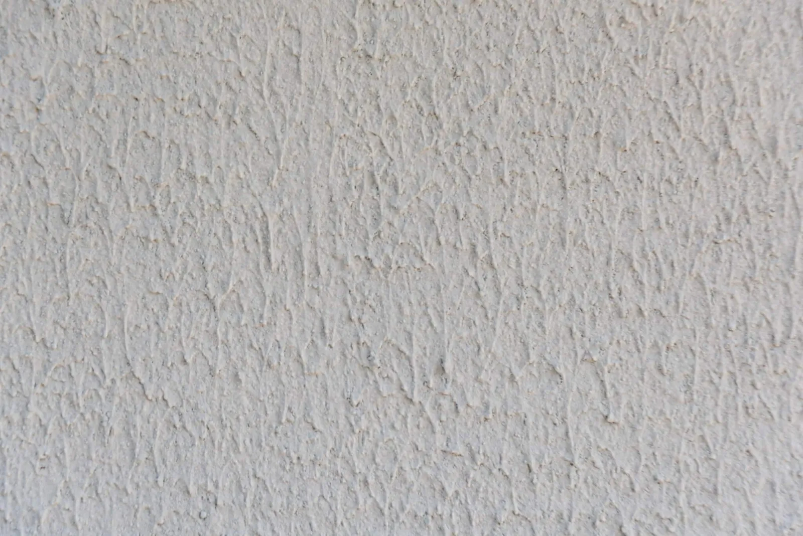 Texture d'enduit de façade blanc à finition grattée